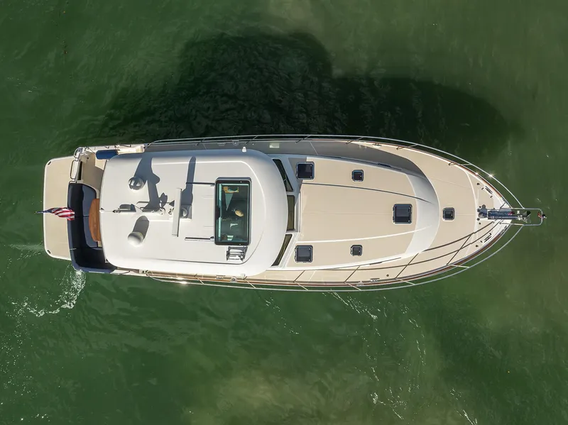 Slide: The Image of Aerial view of 2023 Sabre 48 Salon Express yacht on green water. - 27