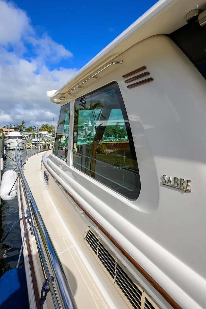Slide: The Image of 2023 Sabre 48 Salon Express yacht docked under blue sky. - 28