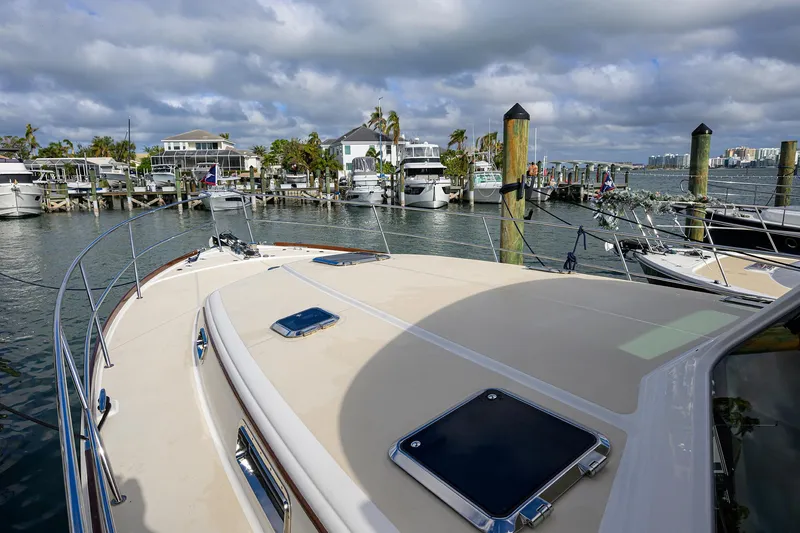 Slide: The Image of 2023 Sabre 48 Salon Express yacht docked at a marina under cloudy skies. - 29