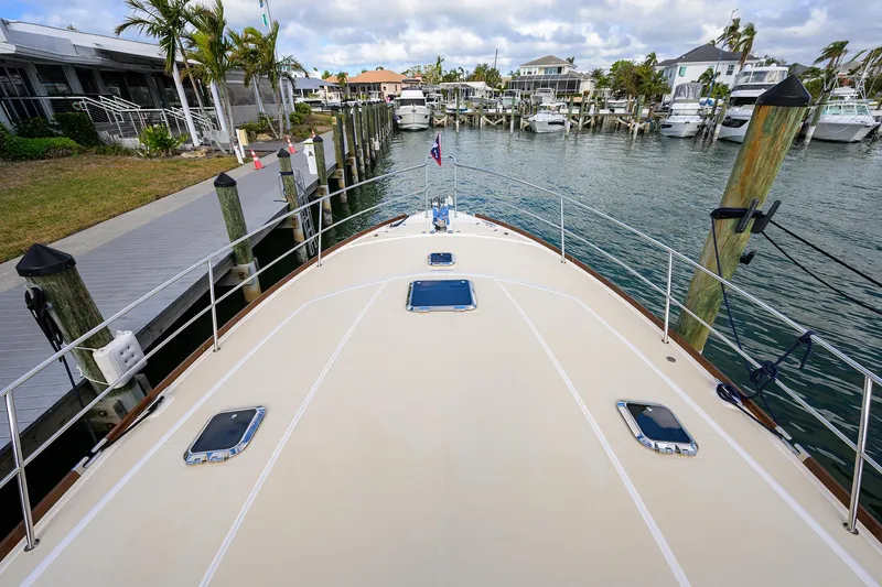 Slide: The Image of 2023 Sabre 48 Salon Express yacht docked in a marina, view from the bow. - 30