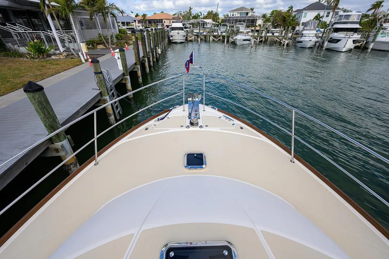 Slide: The Image of 2023 Sabre 48 Salon Express yacht docked at marina, view from bow. - 31