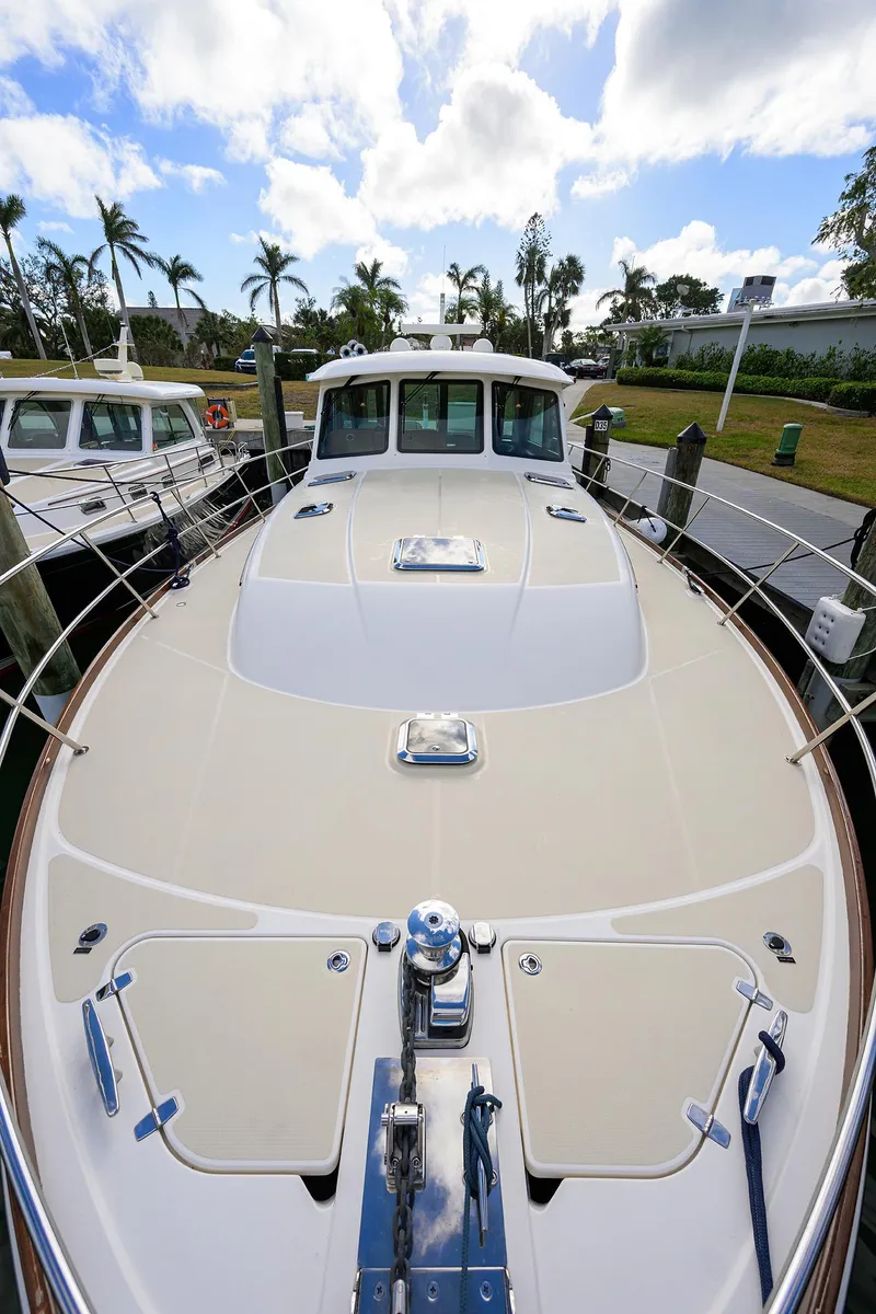 Slide: The Image of 2023 Sabre 48 Salon Express yacht docked under a partly cloudy sky. - 32