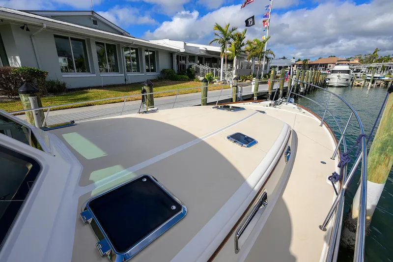 Slide: The Image of 2023 Sabre 48 Salon Express yacht docked at marina with waterfront view. - 34