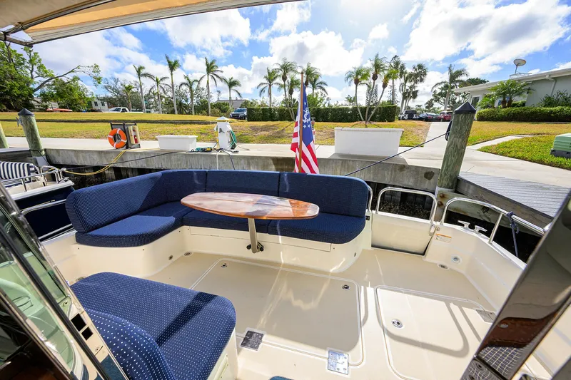 Slide: The Image of 2023 Sabre 48 Salon Express yacht with blue seating and wooden table on deck. - 36