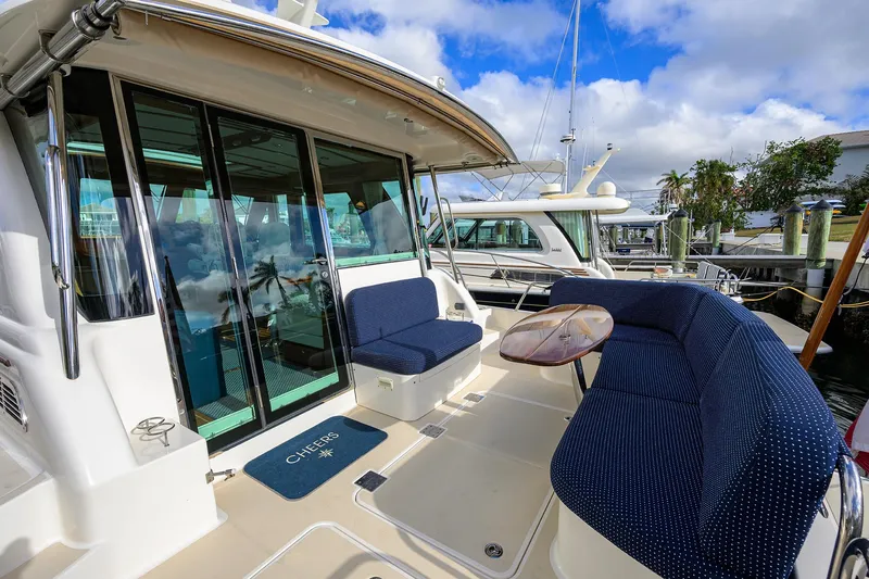 Slide: The Image of 2023 Sabre 48 Salon Express yacht with outdoor seating and table, docked at marina. - 37