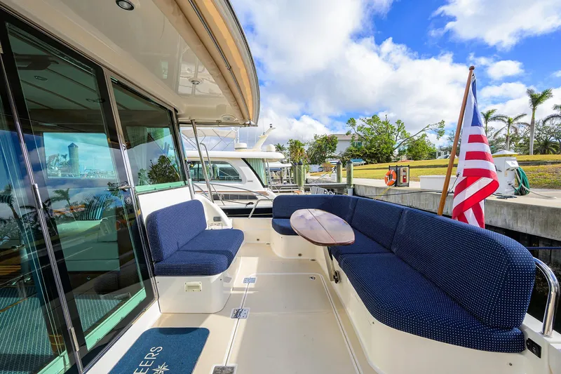 Slide: The Image of 2023 Sabre 48 Salon Express yacht with blue seating and American flag. - 38