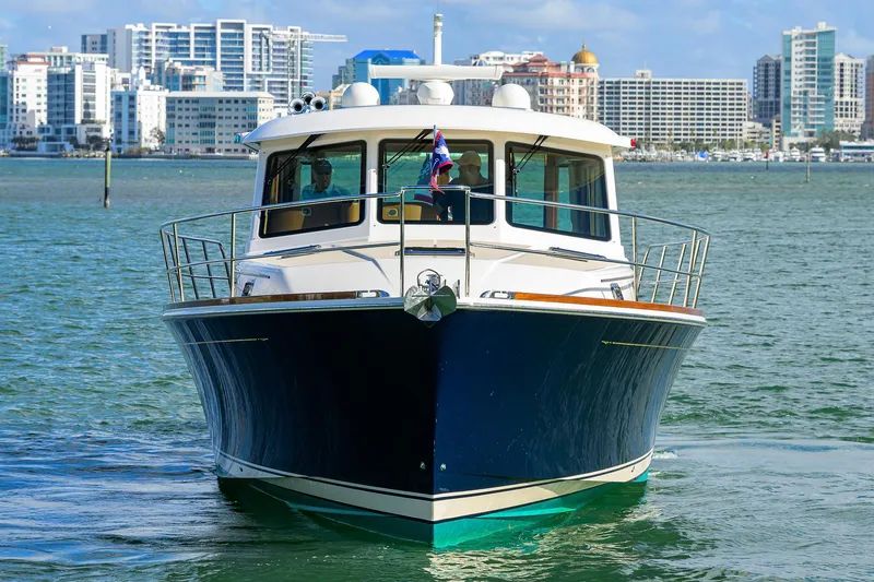 Slide: The Image of 2023 Sabre 48 Salon Express yacht on water with city skyline background. - 4