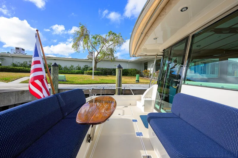 Slide: The Image of 2023 Sabre 48 Salon Express yacht deck with seating and American flag. - 41
