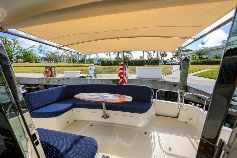Slide: The Image of 2023 Sabre 48 Salon Express yacht with shaded deck and seating area. - 43