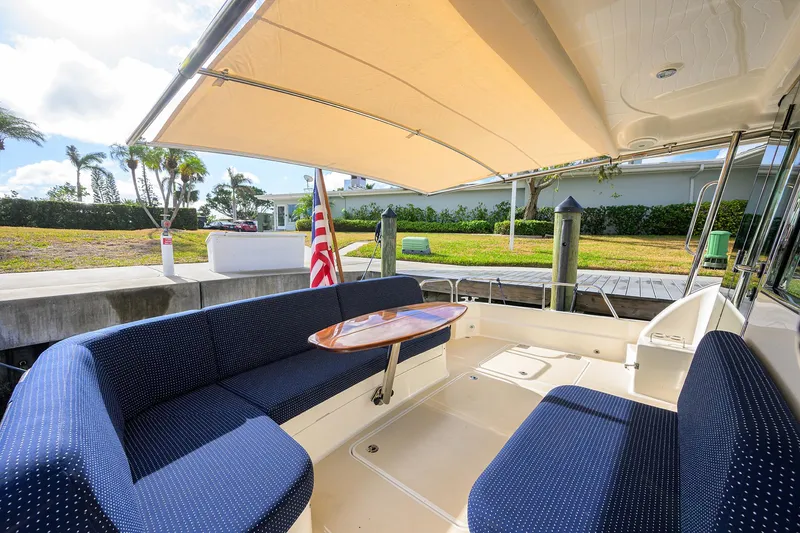 Slide: The Image of 2023 Sabre 48 Salon Express yacht with shaded seating area and elegant interior design. - 45