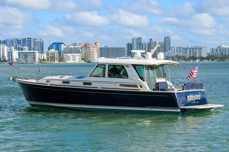 Slide: The Image of 2023 Sabre 48 Salon Express yacht cruising near city skyline. - 9