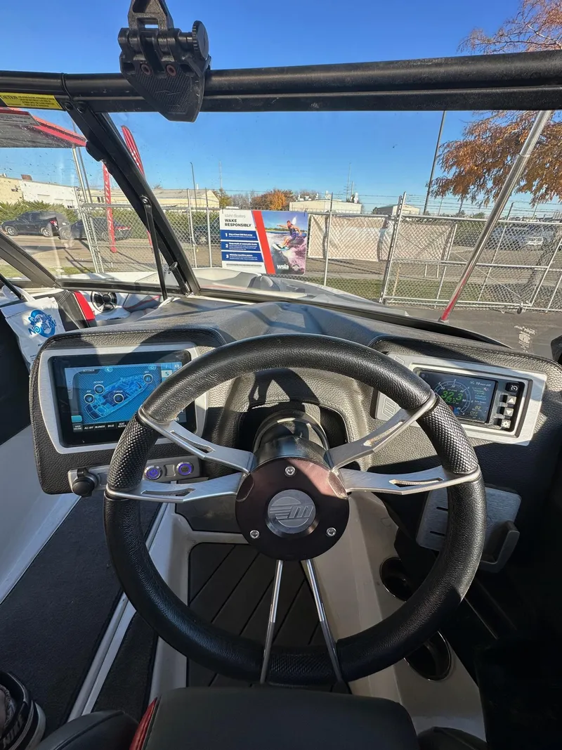Slide: The Image of 2019 Malibu TXi Mo boat dashboard with steering wheel and digital displays. - 16