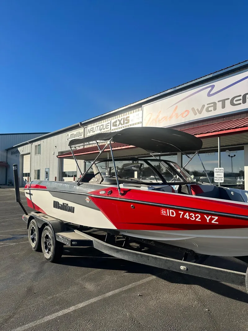 Slide: The Image of 2019 Malibu TXi Mo boat on trailer outside Idaho Water Sports store. - 3