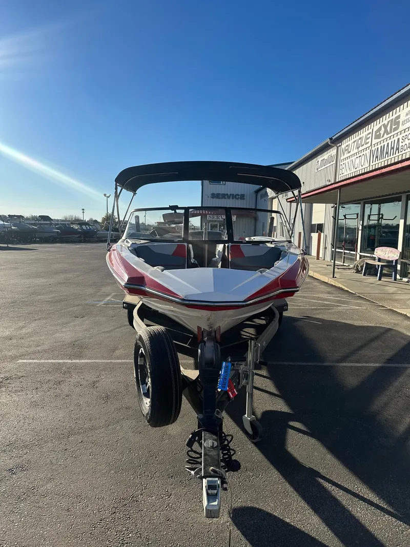 Slide: The Image of 2019 Malibu TXi Mo boat on trailer in sunny dealership lot. - 4