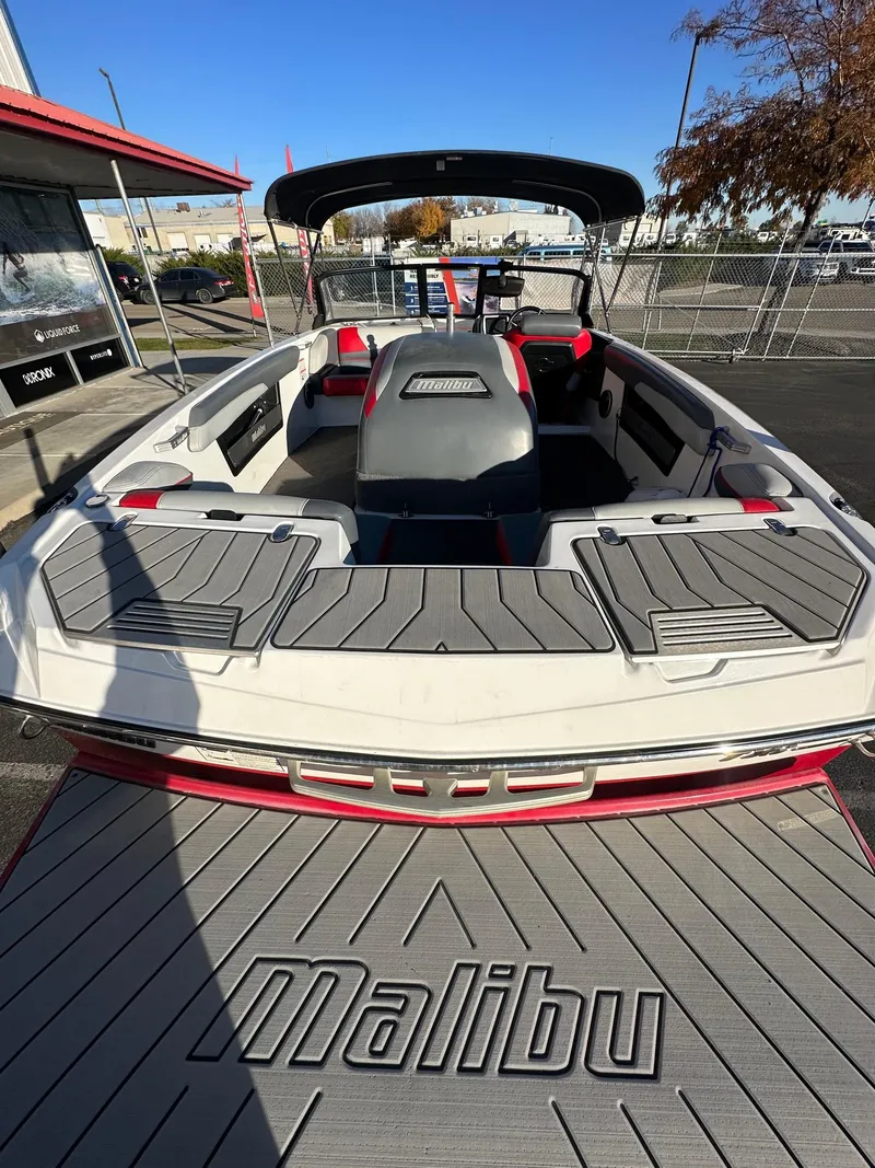 Slide: The Image of 2019 Malibu TXi Mo boat with spacious interior and sleek design. - 9