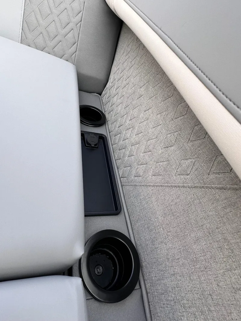 Slide: The Image of Interior of 2025 Bennington 22MFB boat with cup holders and diamond-patterned upholstery. - 15