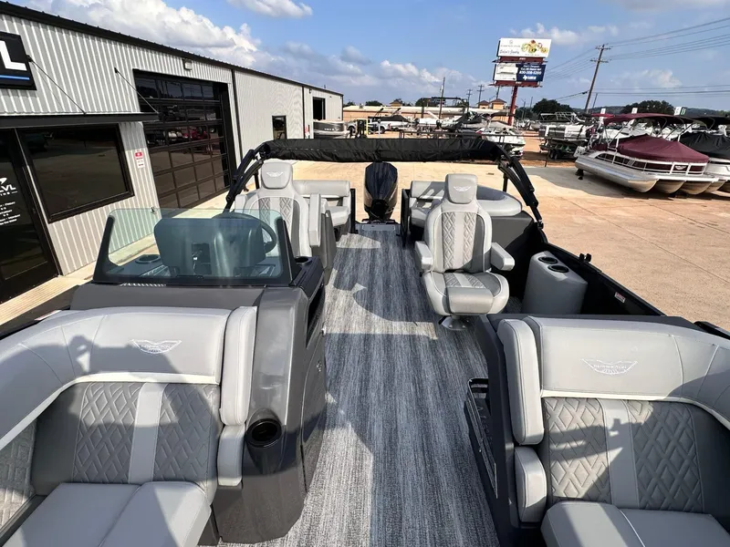 Slide: The Image of 2025 Bennington 22MFB pontoon boat with luxurious seating and modern design at a dealership. - 16