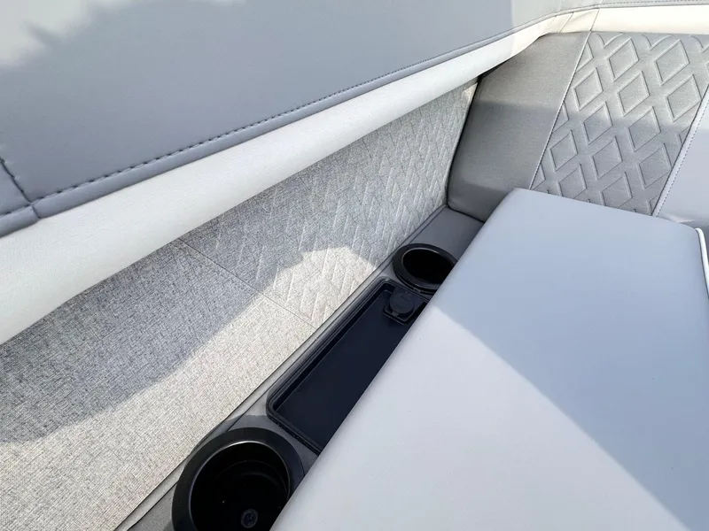 Slide: The Image of 2025 Bennington 22MFB boat interior with cup holders and quilted upholstery. - 17