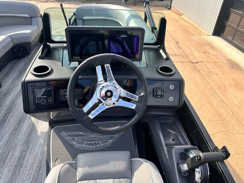 Slide: The Image of 2025 Bennington 22MFB boat dashboard with steering wheel and modern controls. - 23
