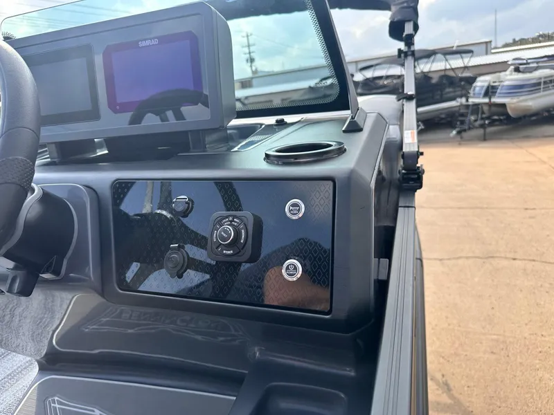 Slide: The Image of 2025 Bennington 22MFB boat dashboard with Simrad display and control panel. - 25