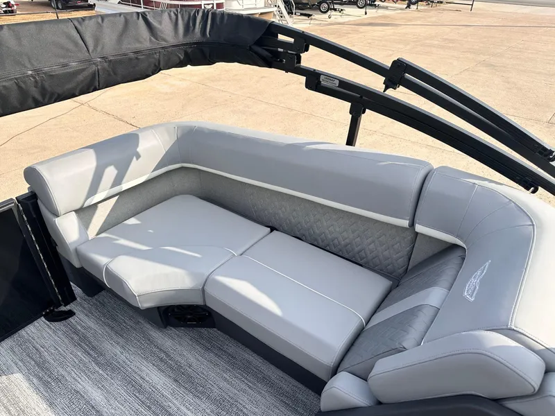 Slide: The Image of 2025 Bennington 22MFB boat interior with gray cushioned seating and elegant design. - 29
