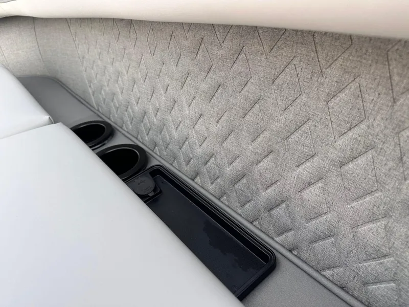 Slide: The Image of 2025 Bennington 22MFB interior with textured upholstery and cup holders. - 30