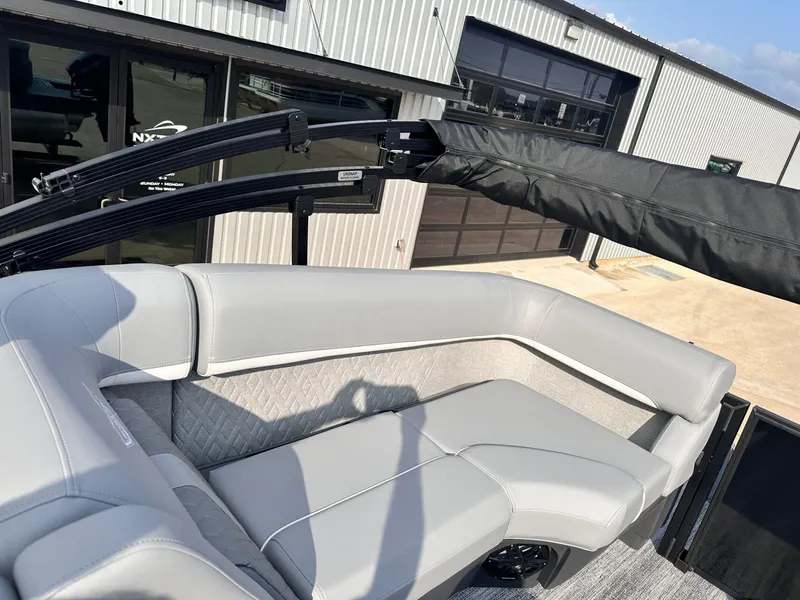 Slide: The Image of 2025 Bennington 22MFB boat interior with gray seating and covered canopy. - 31