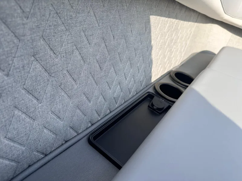 Slide: The Image of 2025 Bennington 22MFB interior with textured upholstery and cup holders. - 32