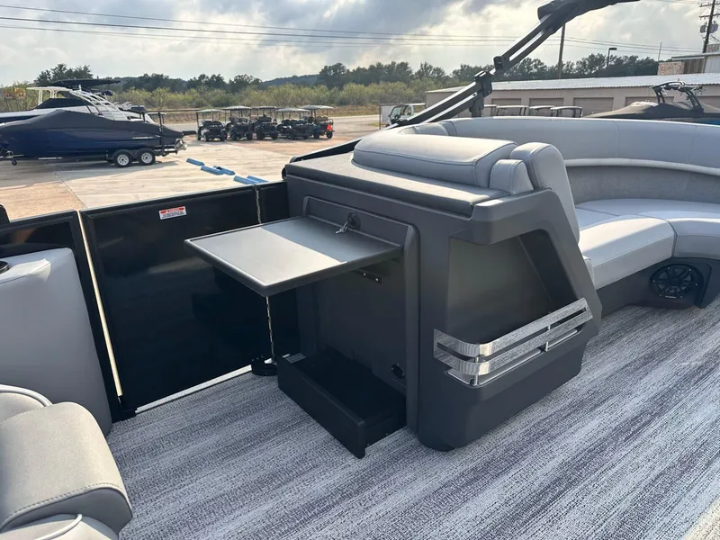 Slide: The Image of 2025 Bennington 22MFB pontoon boat interior with seating and fold-out table. - 33