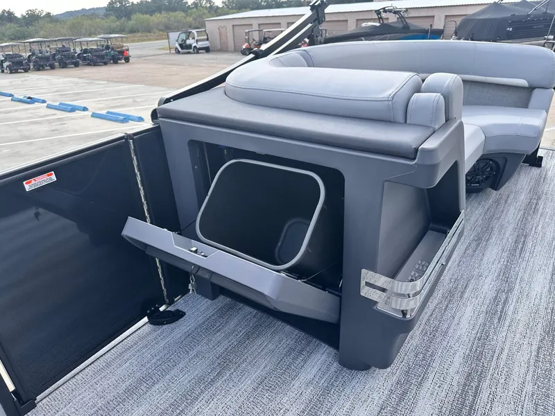 Slide: The Image of 2025 Bennington 22MFB boat interior with open storage compartment and seating. - 34