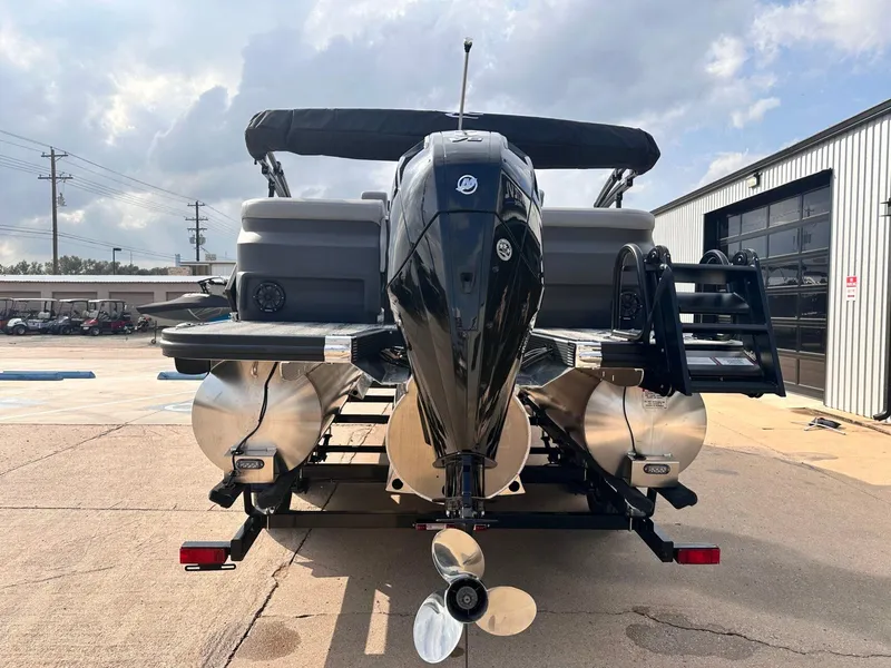 Slide: The Image of 2025 Bennington 22MFB pontoon boat with powerful outboard motor, parked outdoors. - 5