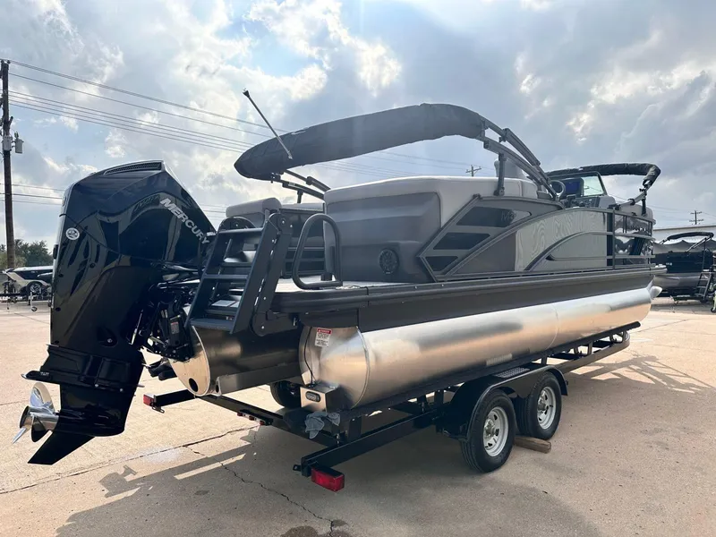 Slide: The Image of 2025 Bennington 22MFB pontoon boat on trailer, featuring a Mercury outboard motor. - 8