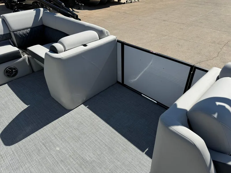 Slide: The Image of 2022 Harris Sunliner 250 boat interior with gray seating and flooring. - 11