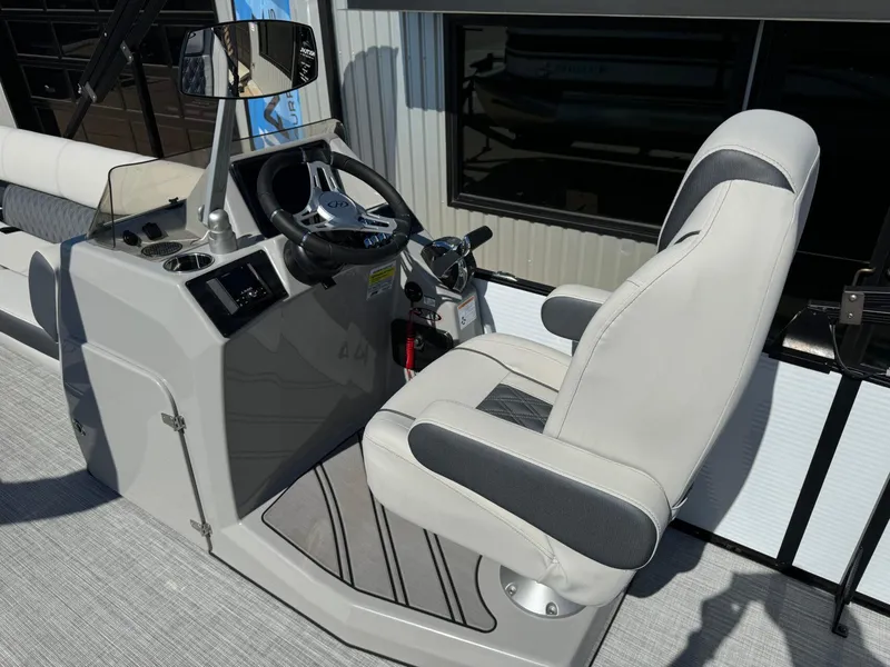 Slide: The Image of Captain's seat and helm of 2022 Harris Sunliner 250 boat, featuring modern controls and steering. - 13