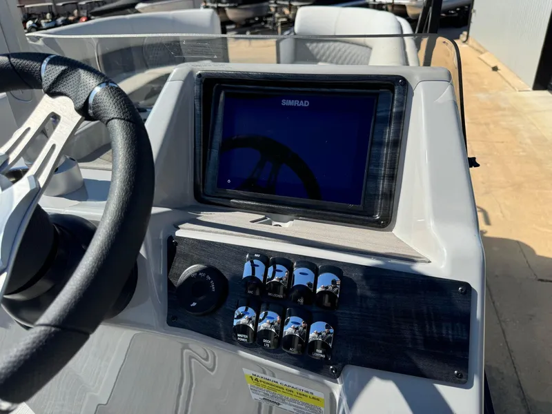 Slide: The Image of 2022 Harris Sunliner 250 dashboard with steering wheel and Simrad display. - 16