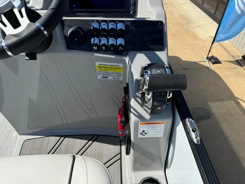 Slide: The Image of Control panel of 2022 Harris Sunliner 250 boat, featuring steering wheel and throttle controls. - 17