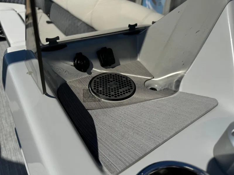 Slide: The Image of 2022 Harris Sunliner 250 boat dashboard with speaker and USB ports. - 19