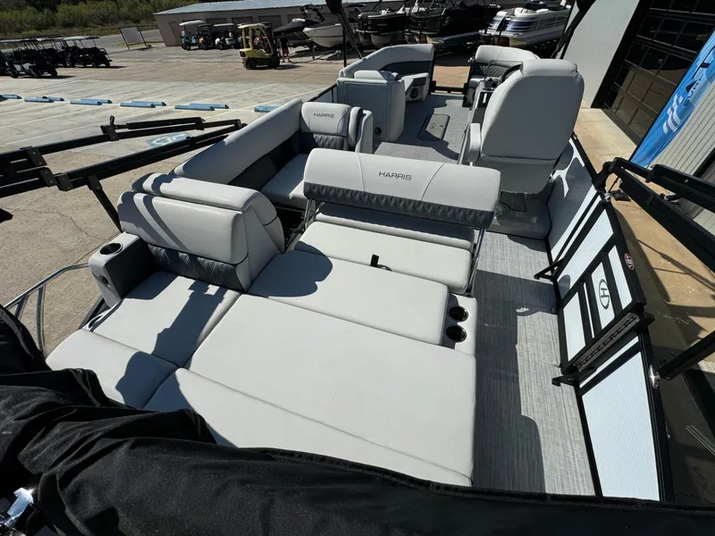 Slide: The Image of 2022 Harris Sunliner 250 pontoon boat with spacious seating and modern design. - 23