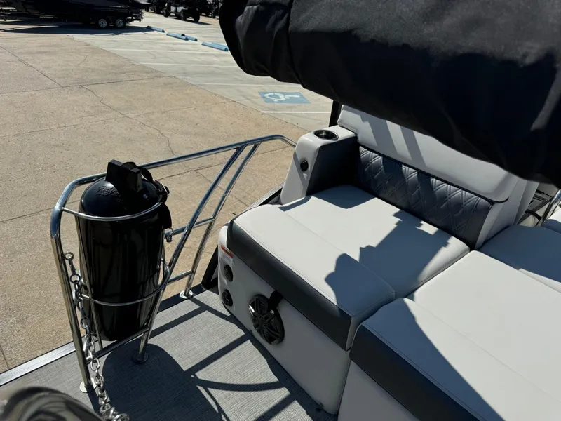 Slide: The Image of 2022 Harris Sunliner 250 boat interior with cushioned seating and railing. - 25