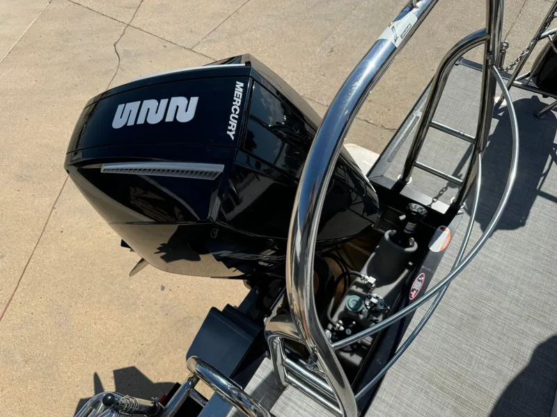 Slide: The Image of 2022 Harris Sunliner 250 with Mercury outboard motor, featuring sleek design and stainless steel railing. - 26