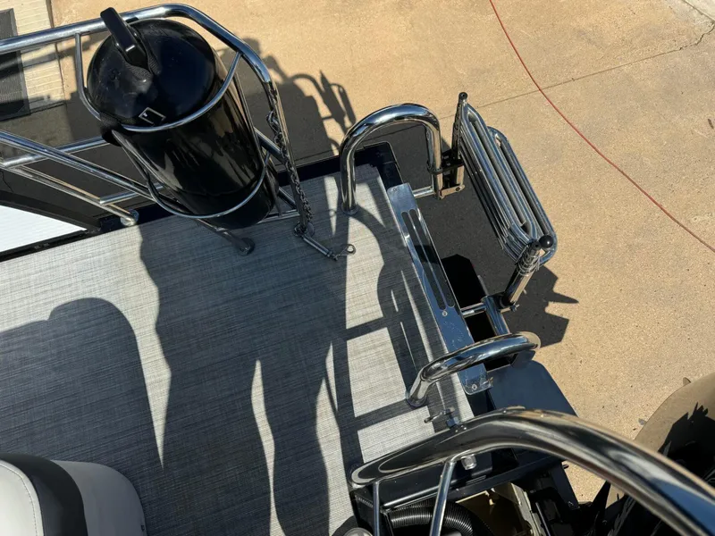 Slide: The Image of 2022 Harris Sunliner 250 boat deck with stainless steel railing and ladder. - 27