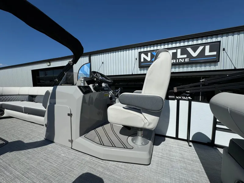 Slide: The Image of 2022 Harris Sunliner 250 boat interior with helm and seating, displayed at NXT LVL Marine. - 29