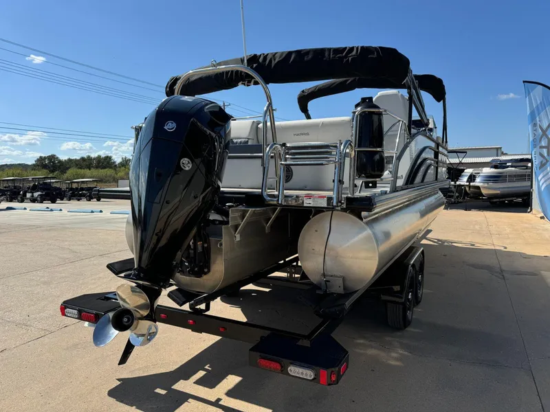Slide: The Image of 2022 Harris Sunliner 250 pontoon boat with outboard motor on trailer. - 3