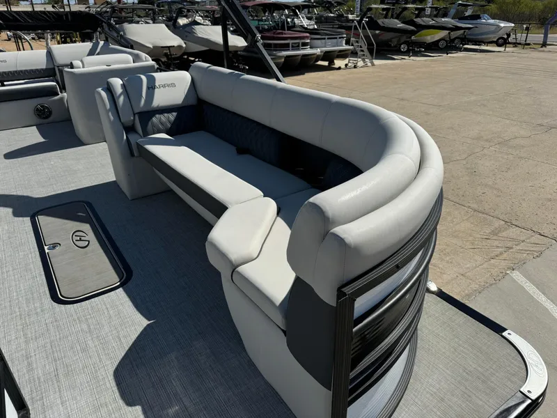 Slide: The Image of 2022 Harris Sunliner 250 pontoon boat with spacious seating and modern design. - 7