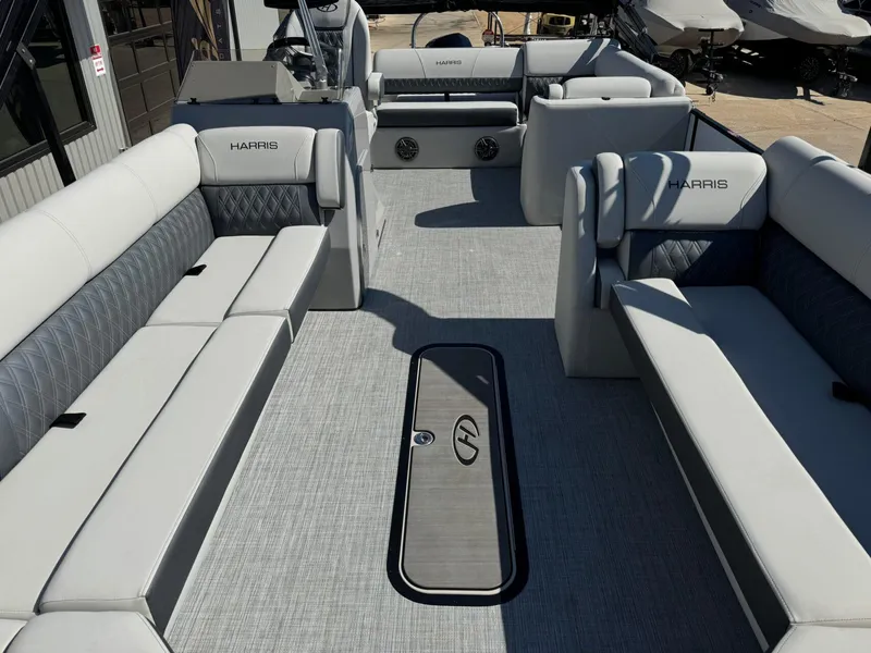 Slide: The Image of 2022 Harris Sunliner 250 boat interior with spacious seating and modern design. - 9