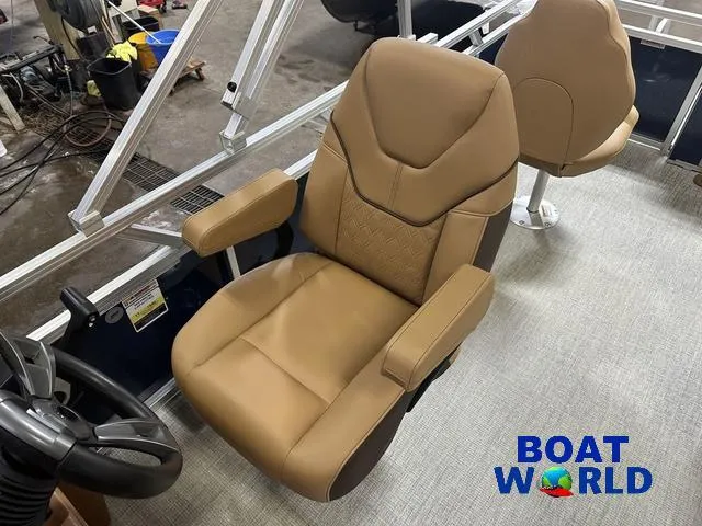 Slide: The Image of 2025 Tahoe Sport 23' Fish & Cruise boat interior with tan captain's chair. - 12