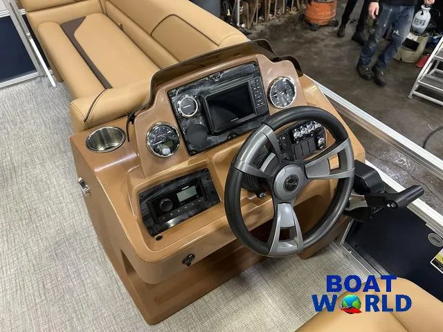 Slide: The Image of 2025 Tahoe Sport 23' Fish & Cruise boat dashboard with steering wheel and controls. - 13