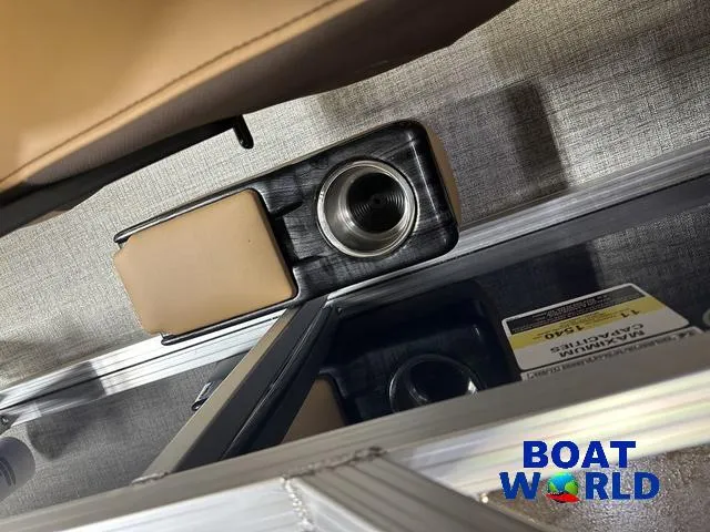 Slide: The Image of 2025 Tahoe Sport 23' Fish & Cruise boat interior with cup holder, Boat World logo. - 16