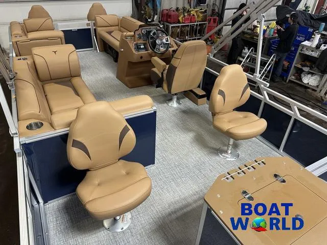 Slide: The Image of 2025 Tahoe Sport 23' Fish & Cruise boat interior with tan seating and steering console. - 22