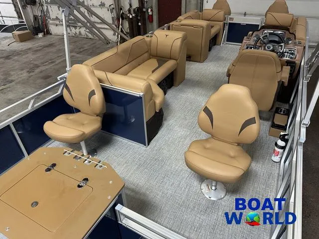 Slide: The Image of 2025 Tahoe Sport 23' Fish & Cruise boat interior with tan seating and modern dashboard. - 23